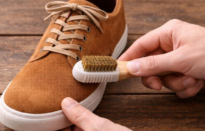 brushing suede shoes with suede brush