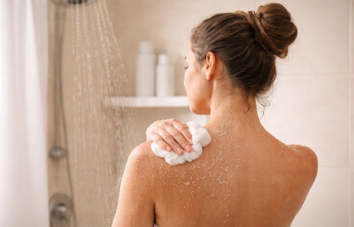 Person taking a lukewarm shower for gentle skin care